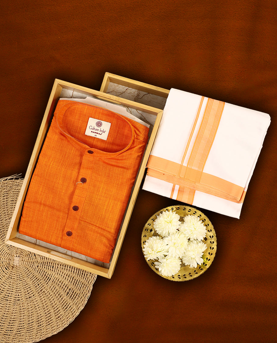 RAMRAJ Orange kurtha paired with a white dhoti, elegantly finished with a matching Orange border.
