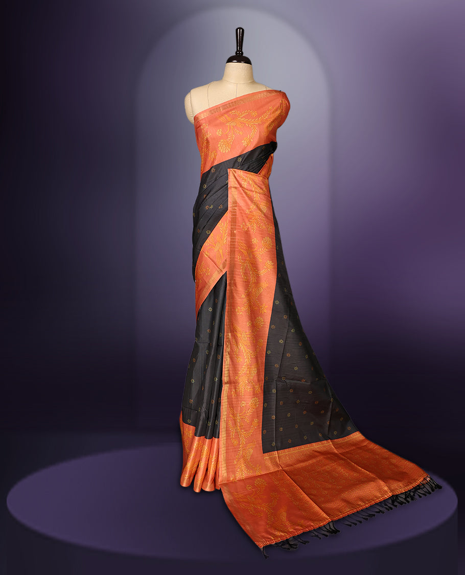 Grey & orange saree adorned with golden buttas, complemented by a rich orange zari border and pallu with floral motifs, paired with a matching blouse.