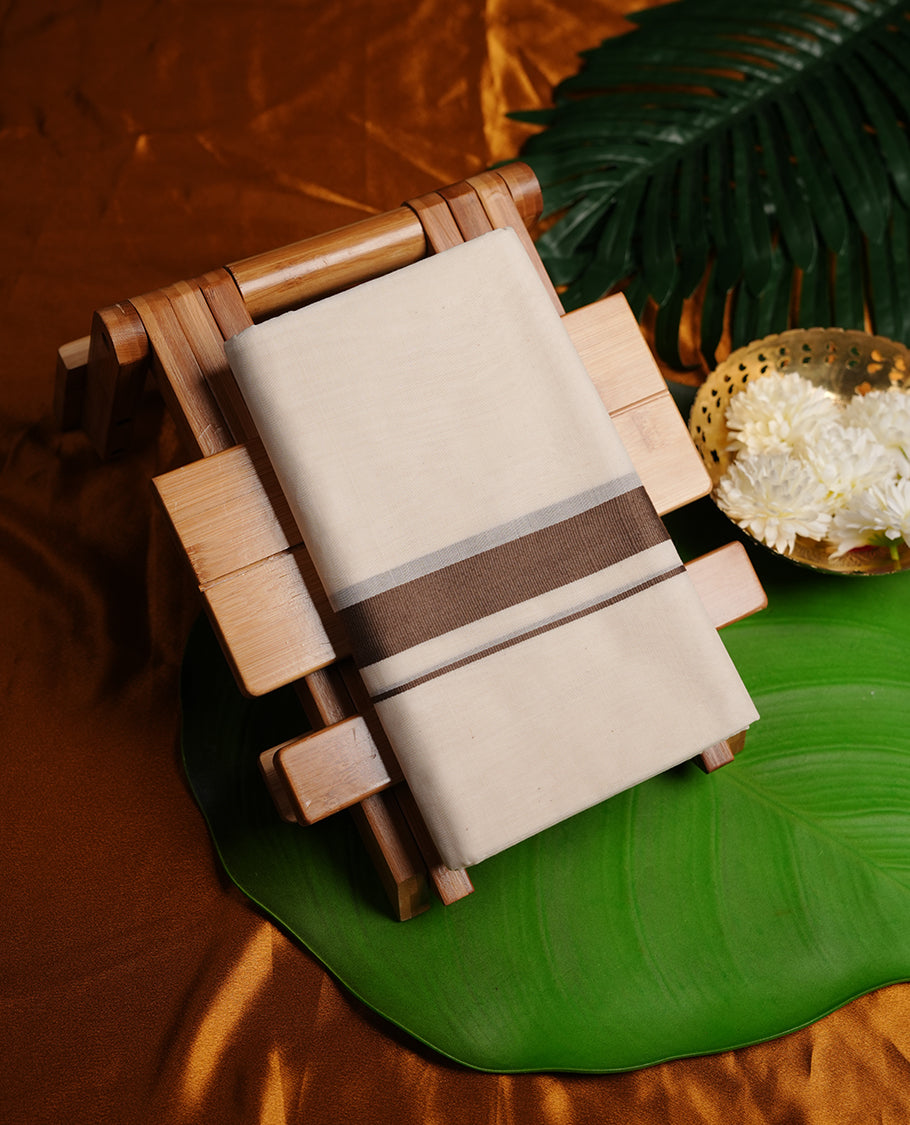 Cream colour double dhoti featuring brown colour zari border