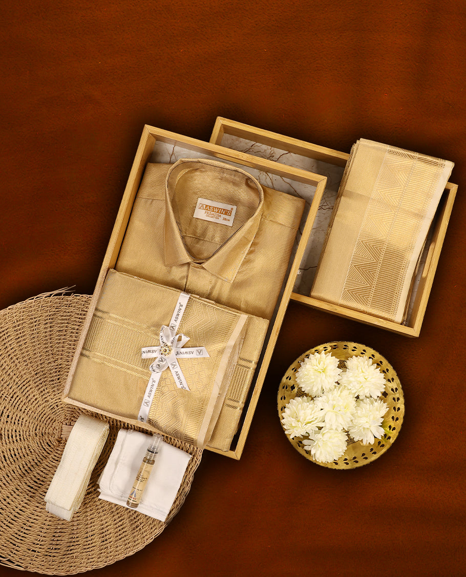 Biscuit colour Aswin’s wedding set featuring a rich silk shirt, matching dhoti, and angavastram adorned with elegant golden zari weave, complemented by a towel and fragrance, perfect for grand festive occasions.