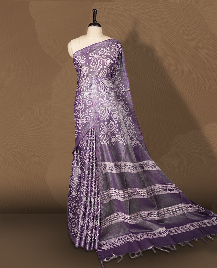 Lavender semi jute tissue saree adorned with elegant white floral motifs all over the body, paired with a beautifully woven pallu and patterned borders & Comes with a matching blouse piece.