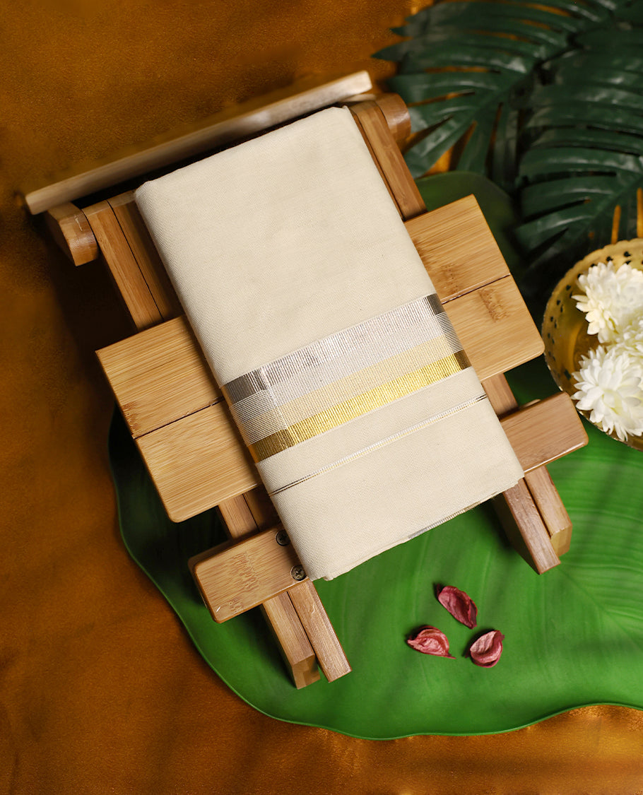 Off white colour cotton double dhoti adorned with a dual tone border in silver and gold zari, highlighted with fine stripe detailing, offering a graceful and festive traditional look perfect for cultural occasions.