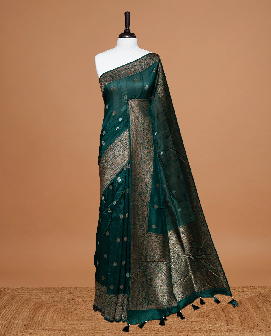 Green colour Semi banaras tussar georgette Saree featuring Antique zari motifs on body, enhanced with antique zari border, paired with a matching blouse piece.