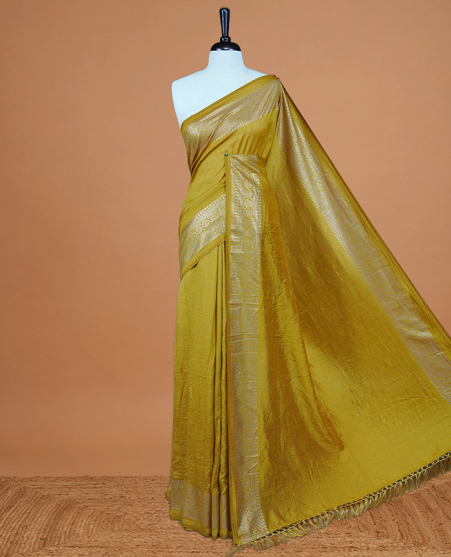 Mustard colour semi silk saree featuring Elegant plain body with fancy border, comes with matching self colour blouse piece.
