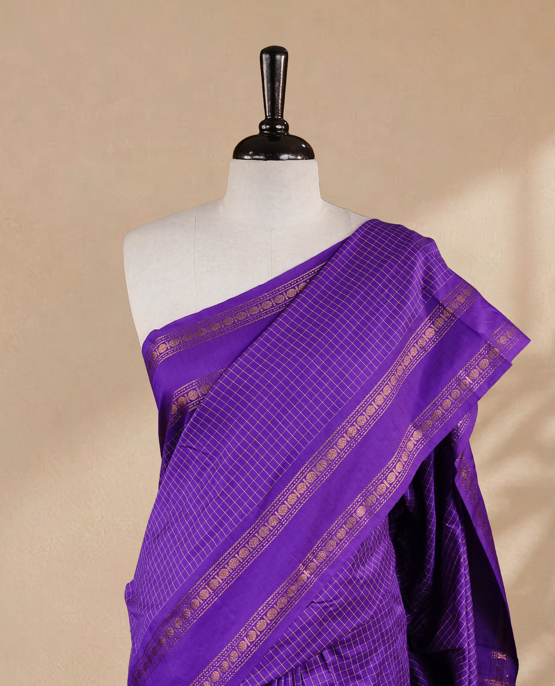 Indigo colour kalyani cotton saree featuring gold zari check pattern on body, complemented by Self colour with Antique zari border, paired with matching blouse piece.