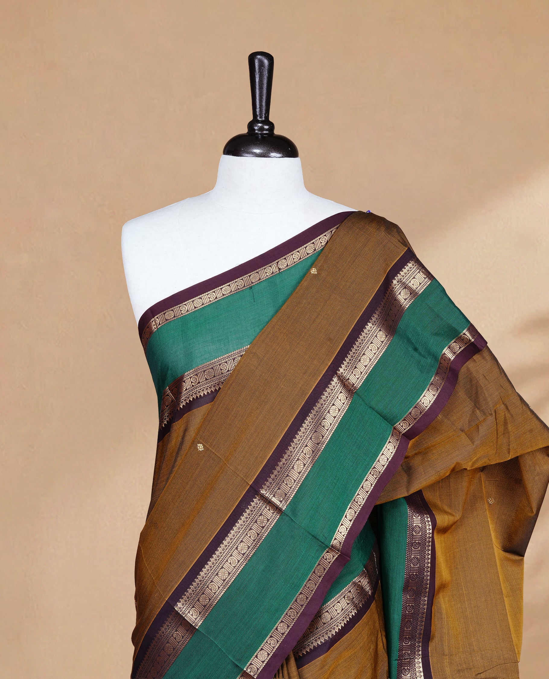 Olive colour Chettinad Silk cotton saree featuring Elegant body, complemented by Contrast Green & Chocolate colour with Gold zari border, paired with matching blouse piece.