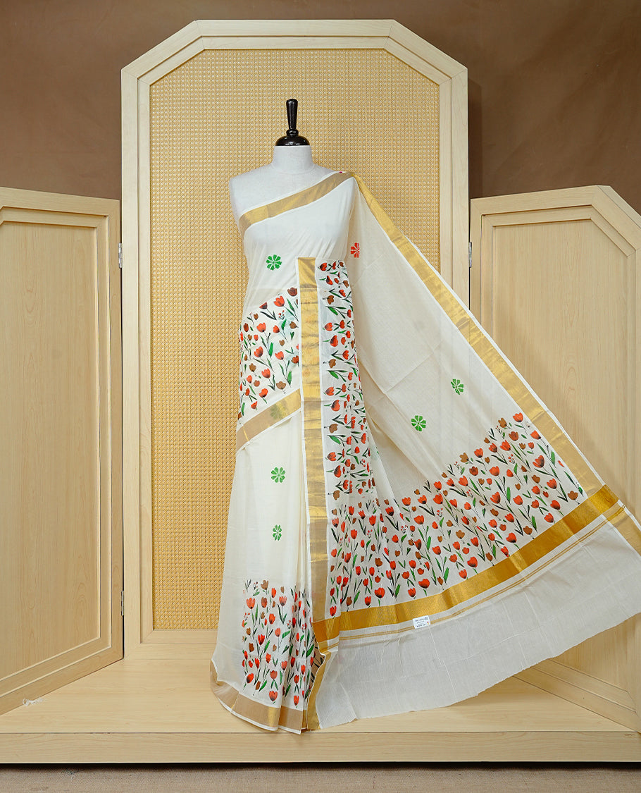 Cream Colour Cotton Kerala Saree Featuring Digital Red & Brown Colour Floral Motifs On Body, With A Classic Gold Zari Border & A Gold Zari Pallu, Paired With A Matching Blouse Piece.