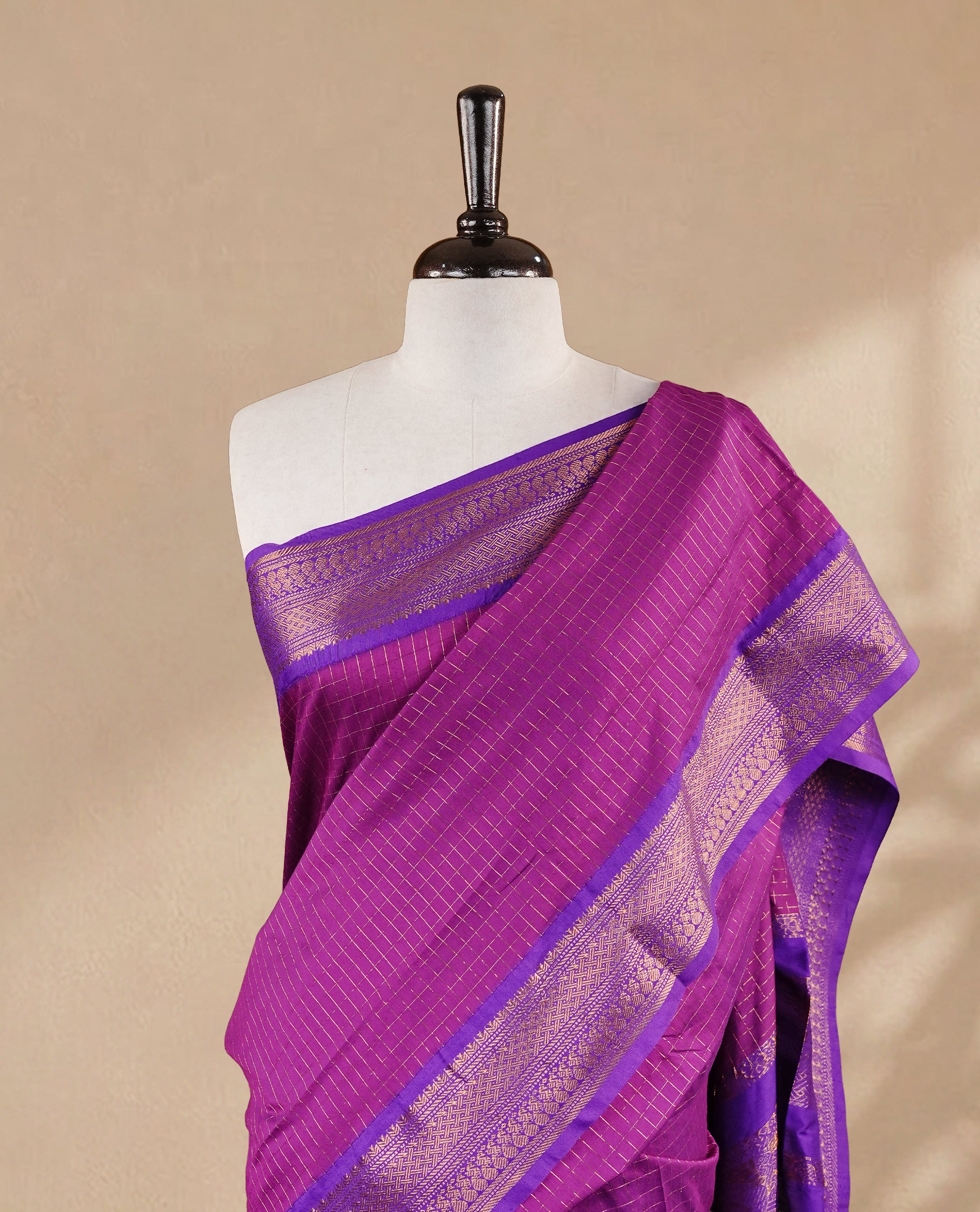 Purple colour kalyani cotton saree featuring gold zari check pattern on body, complemented by Violet colour with Antique zari border, paired with matching blouse piece.
