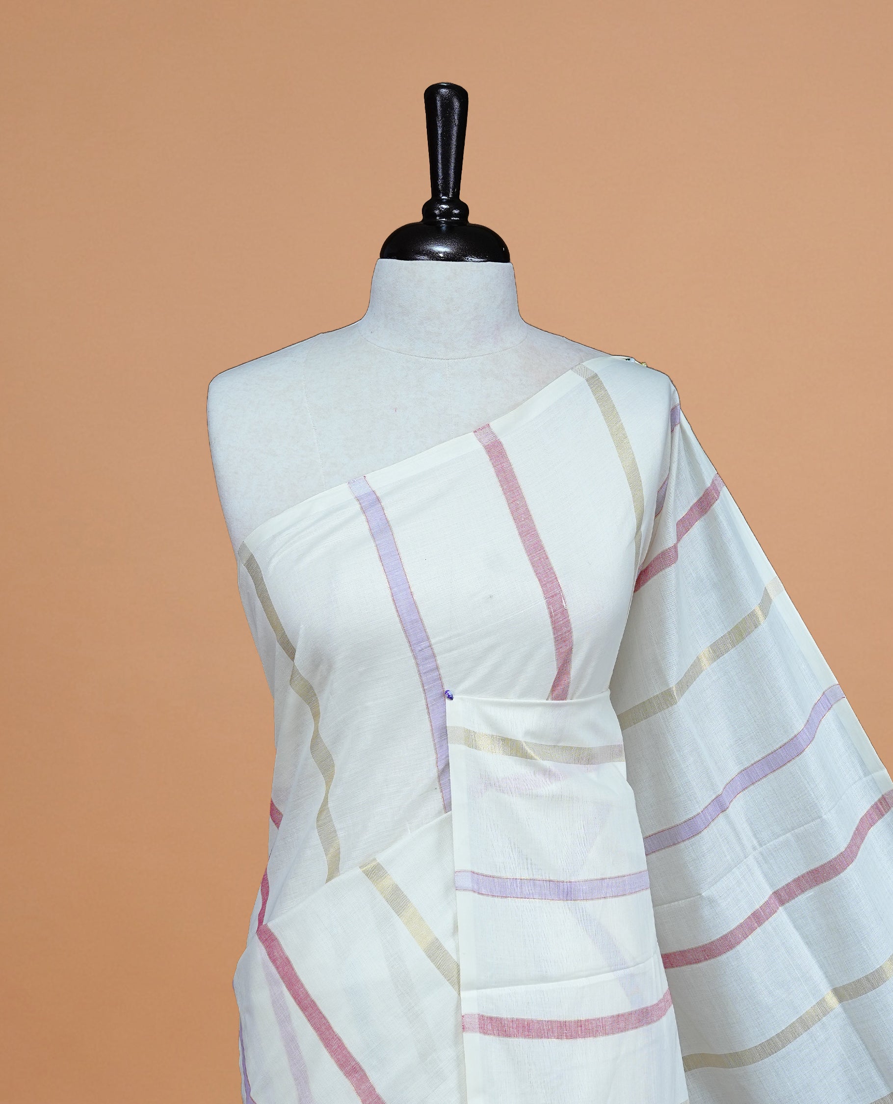 Cream Colour Cotton Kerala Saree Featuring Pastel Red & Lavender Strips On The Body & Pallu, Paired With A Matching Blouse Piece.