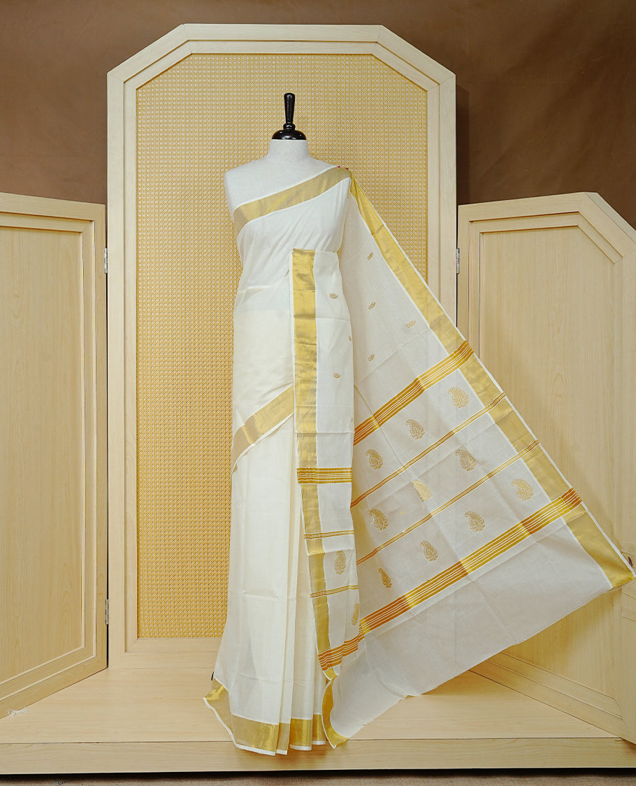 Cream Colour Cotton Kerala Saree Featuring Delicate Gold Mango Motifs Across The Body, Enhanced With A Traditional Gold Zari Border, A Gold Mango & Striped Gold Zari Pallu, Finished With A Matching Blouse Piece