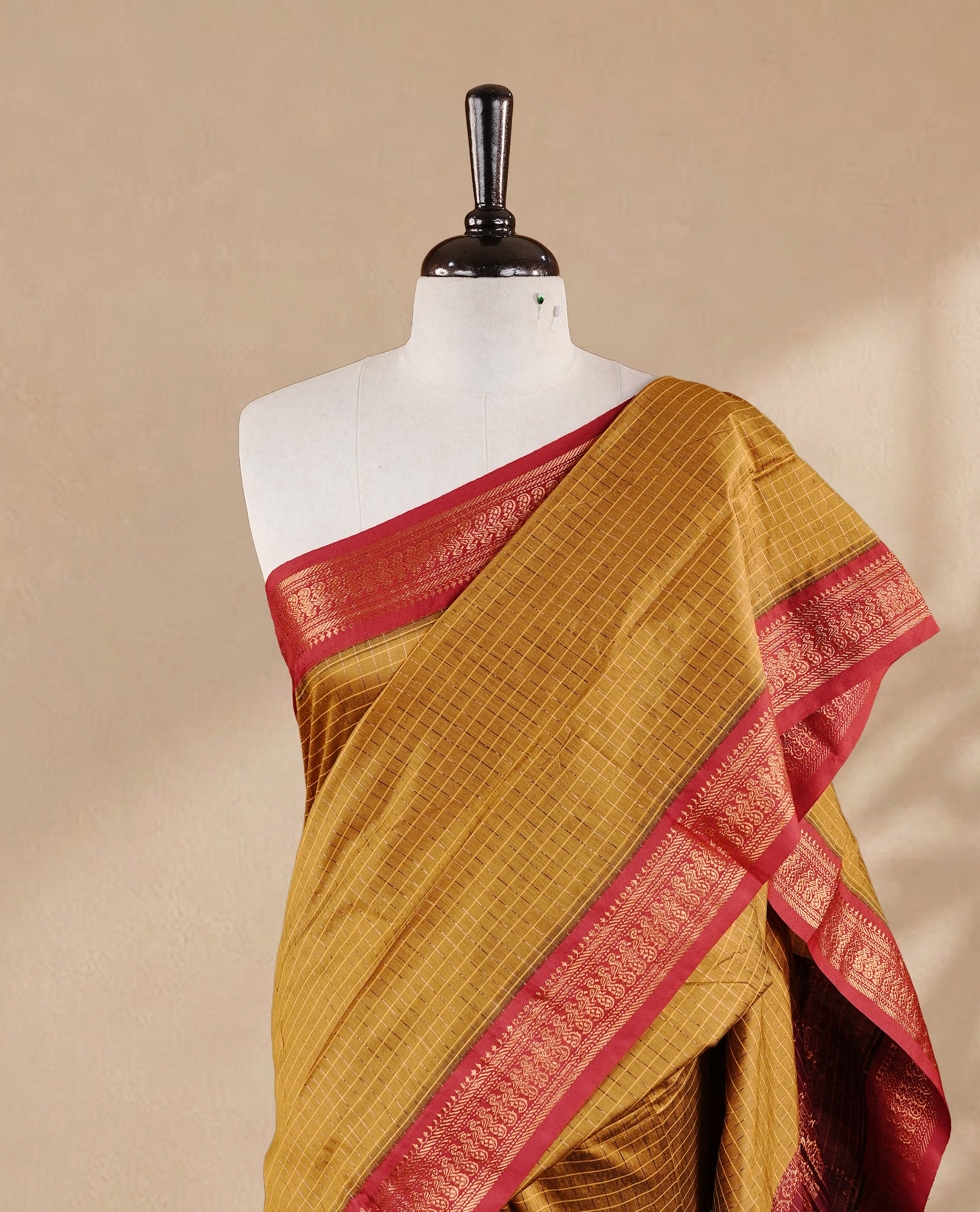Mustard colour kalyani cotton saree featuring antique zari check pattern on body, complemented by Maroon colour with Antique zari border, paired with matching blouse piece.