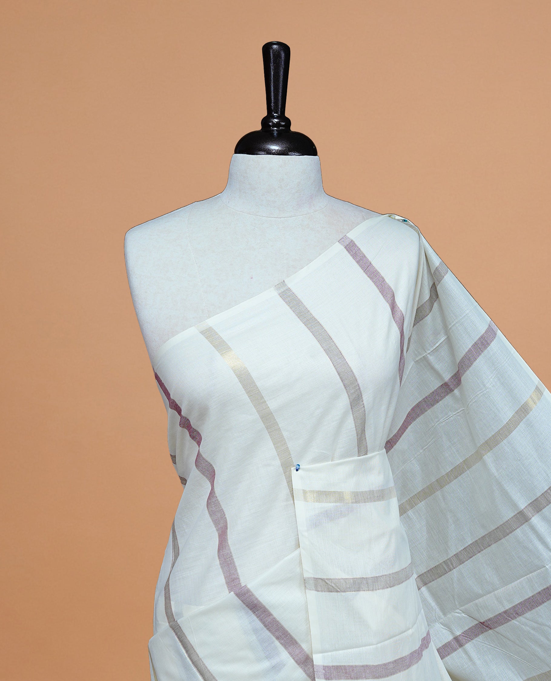 Cream Colour Cotton Kerala Saree Featuring Gray & Light Maroon On The Body & Pallu, Paired With A Matching Blouse Piece.