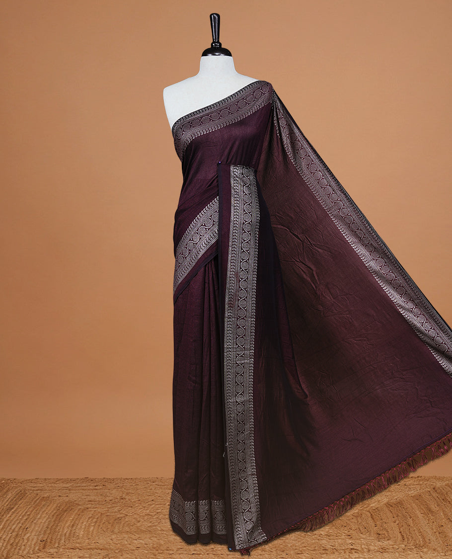 Chocolate colour semi silk saree featuring Elegant plain body with fancy border, comes with matching self colour blouse piece.