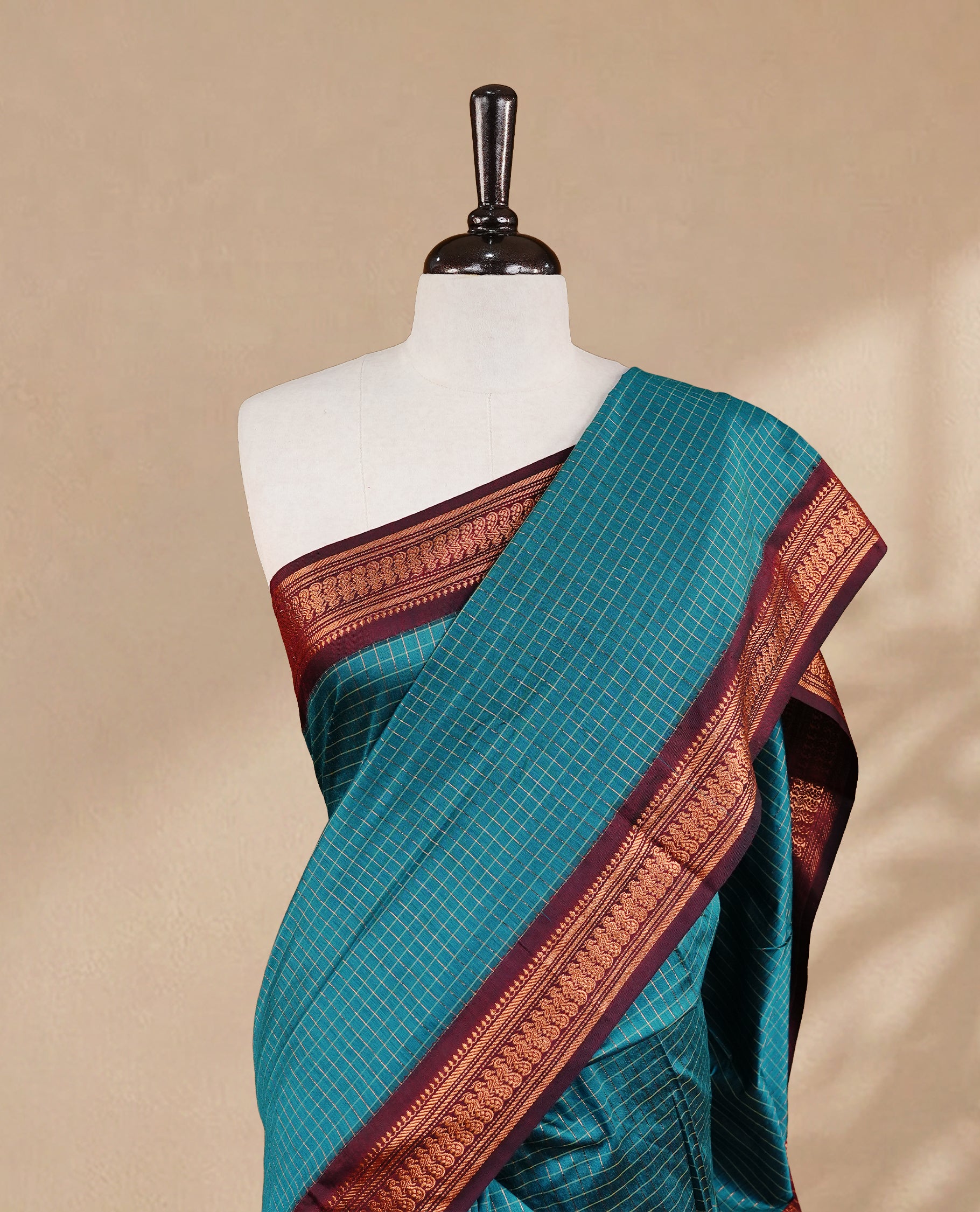 Blue colour kalyani cotton saree featuring antique zari motifs on body, complemented by Maroon colour with Antique zari border, paired with matching blouse piece.