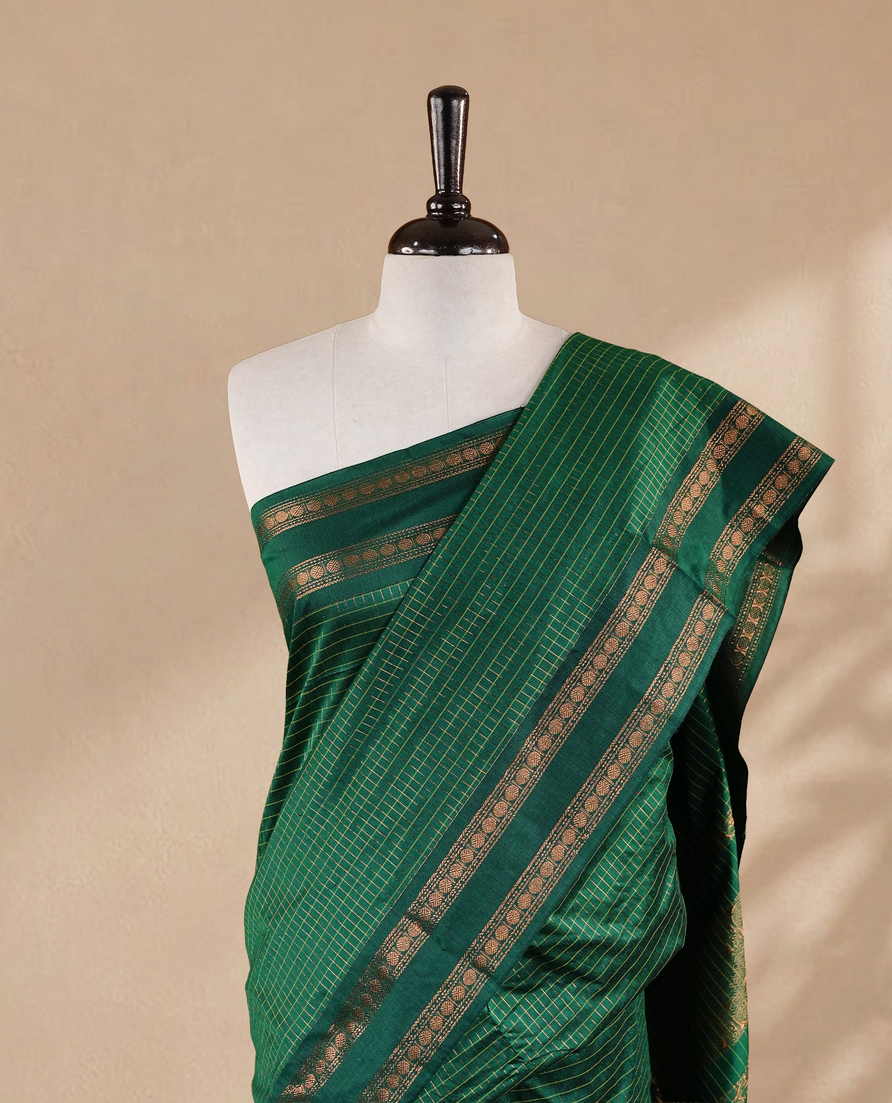 Green colour kalyani cotton saree featuring gold zari check pattern on body, complemented by Self colour with Antique zari border, paired with matching blouse piece.