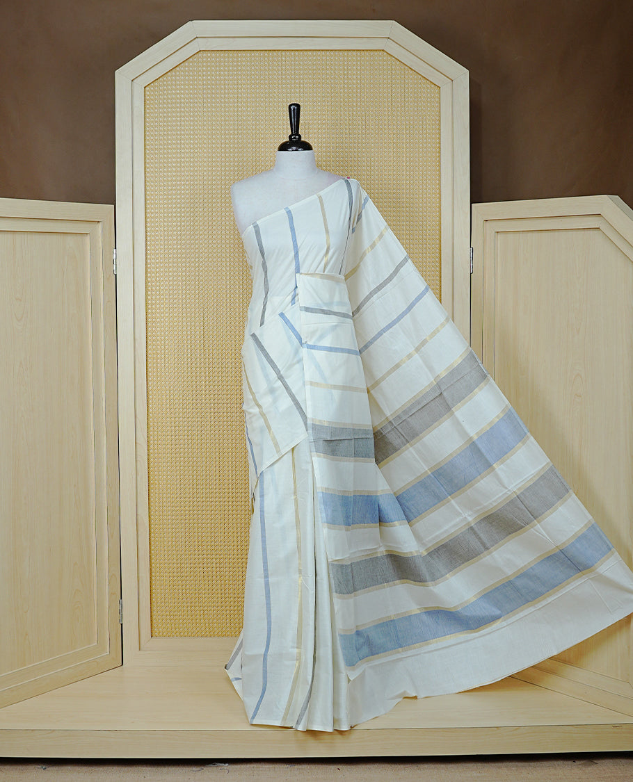 Off White Colour Cotton Kerala Saree Featuring Light Gold & Grey , Blue Zari Stripped Body, Enrich By Zari Border, Pallu ,Comes With Matching Blouse Piece.