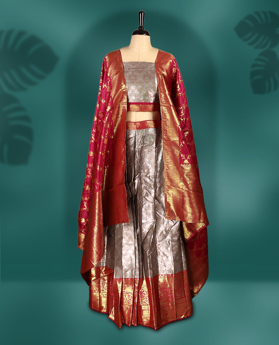 Stunning Semi stitched Rose gold and vibrant majenta Dhavani set featuring a lustrous silver skirt with rich golden zari border, paired with a vibrant majenta dupatta adorned with golden motifs, creating a perfect blend of elegance and tradition.
