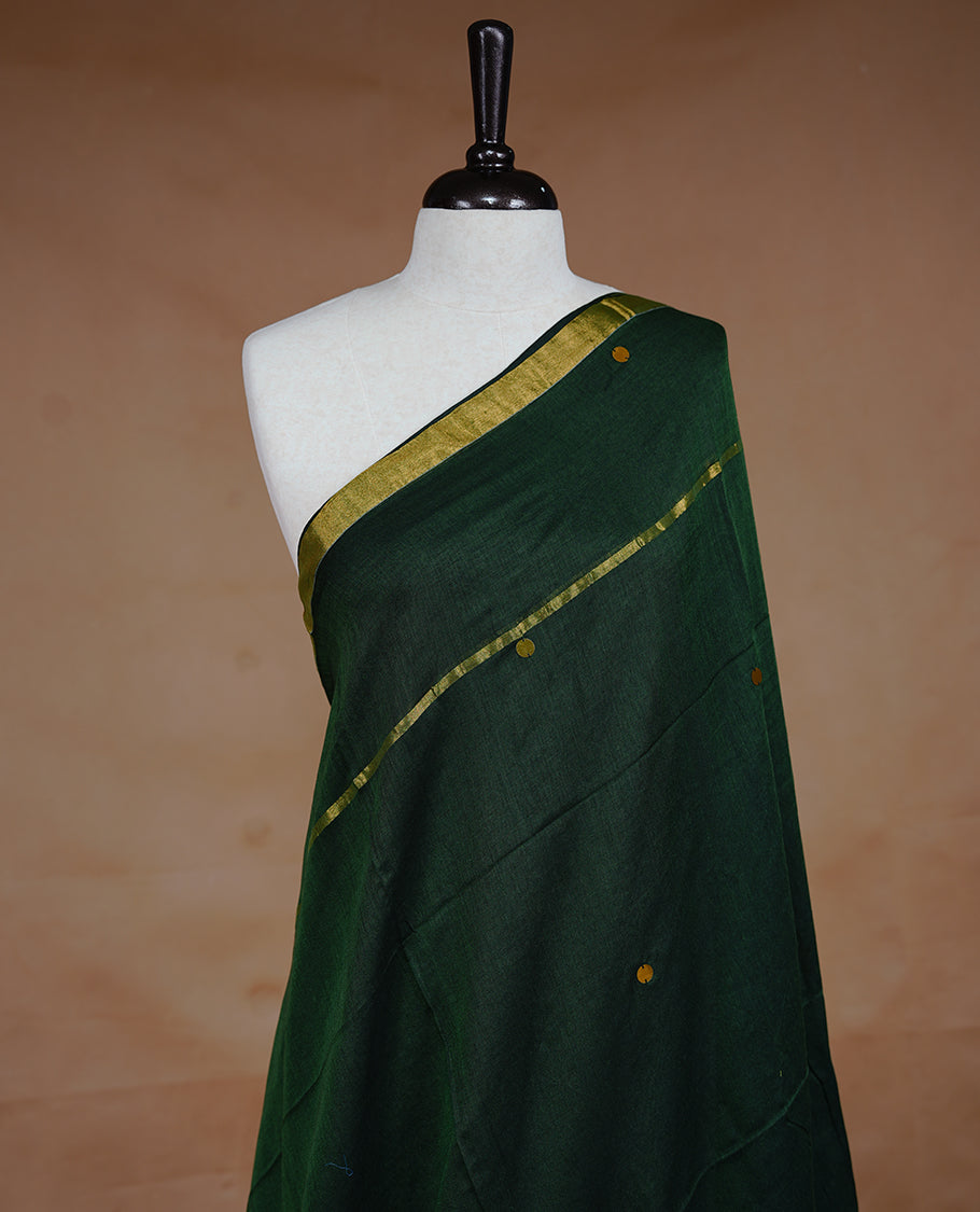 Green colour Mul Cotton saree featuring a plain body with sequin detailing, highlighted by a small gold colour border, without blouse piece.