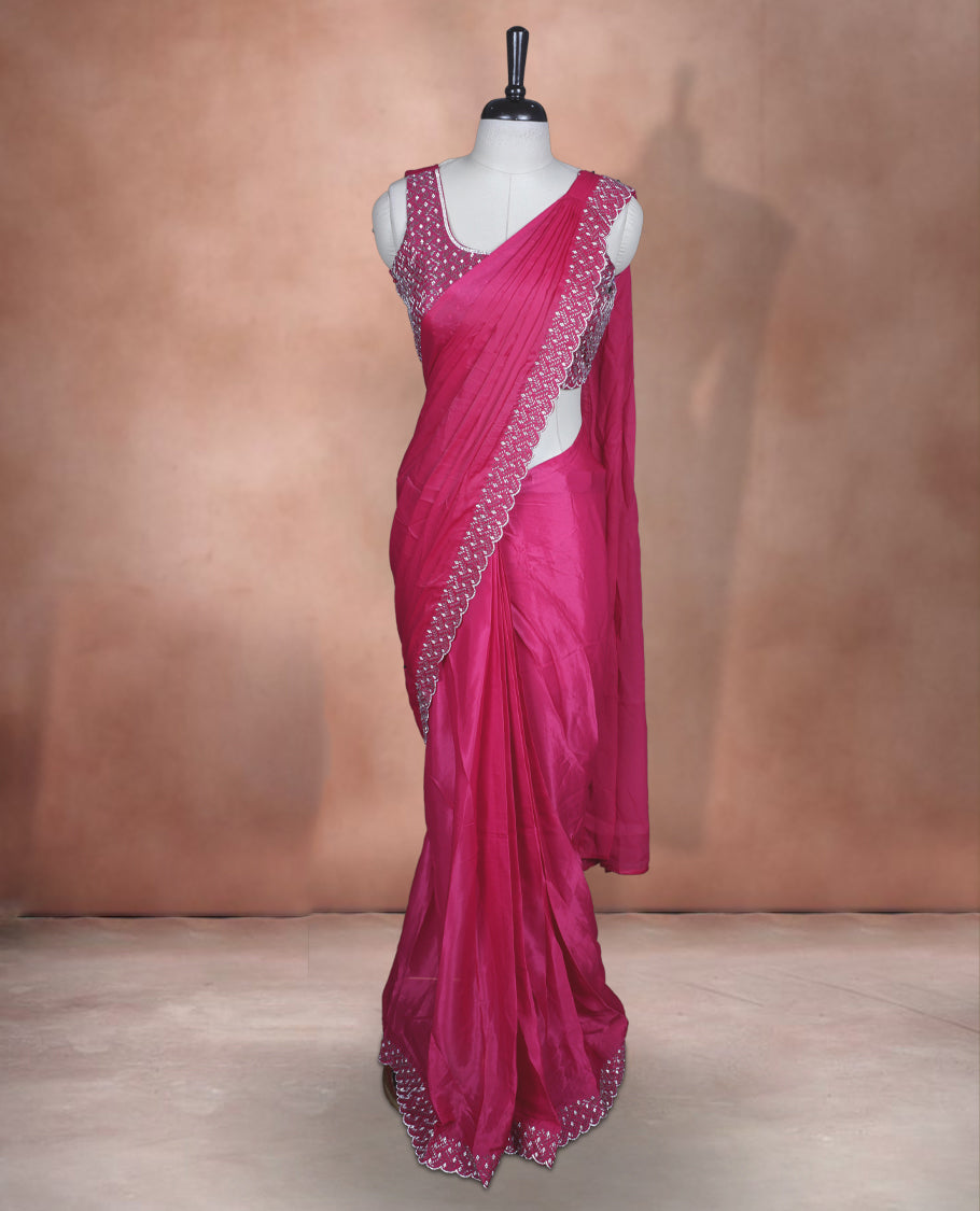 Elegant Rani pink Colour ready to wear saree adorned with rich silver stone and bead embroidery along the border and pallu, paired with a heavily embellished matching blouse for a grand festive look.