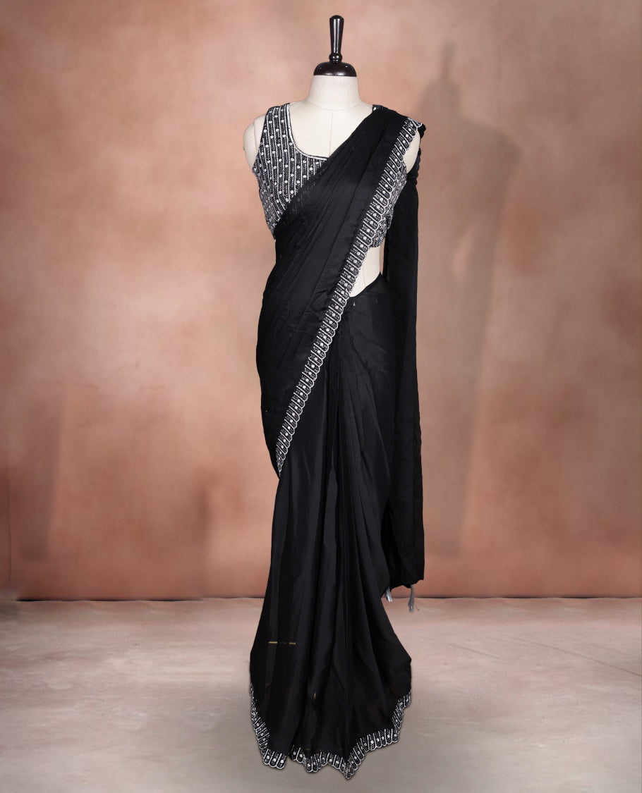 Elegant Black colour ready to wear saree adorned with rich silver stone and bead embroidery along the border and pallu, paired with a heavily embellished matching blouse for a grand festive look.