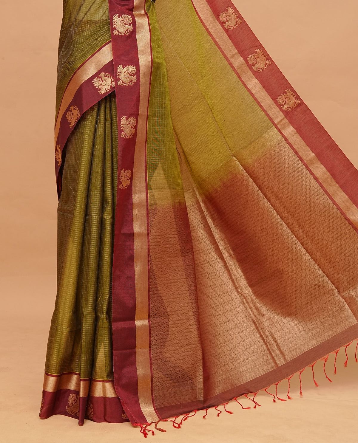 Olive Green colour silk cotton saree featuring copper zari Check motifs on body ,contrast maroon with copper zari motifs on border & pallu, comes with matching blouse piece