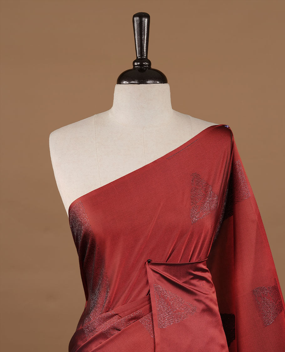 Red colour soft silk saree features a sleek borderless design with intricate antique zari motifs, flowing into a striking contrast green pallu and a matching blouse piece.