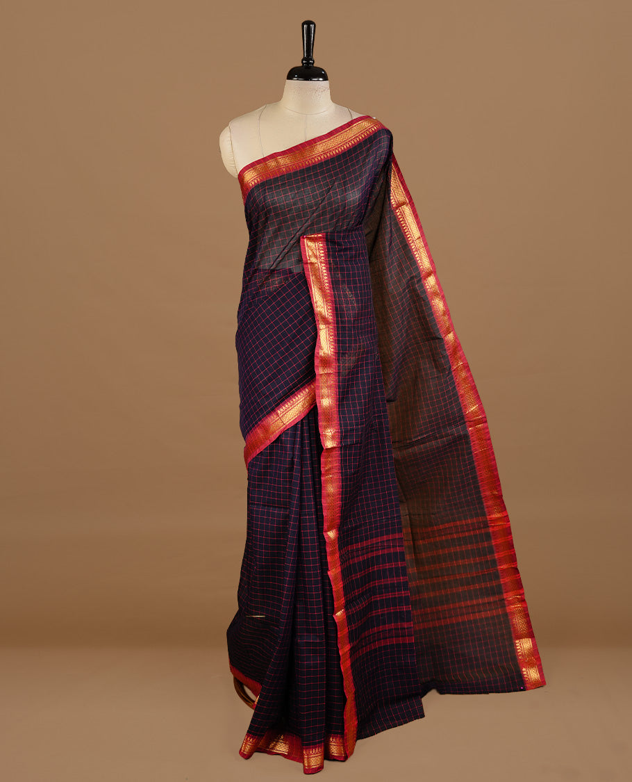 Dark blue colour chettinad cotton saree featuring Check pattern on body, complemented by magenta colour with zari border, paired with matching blouse piece.
