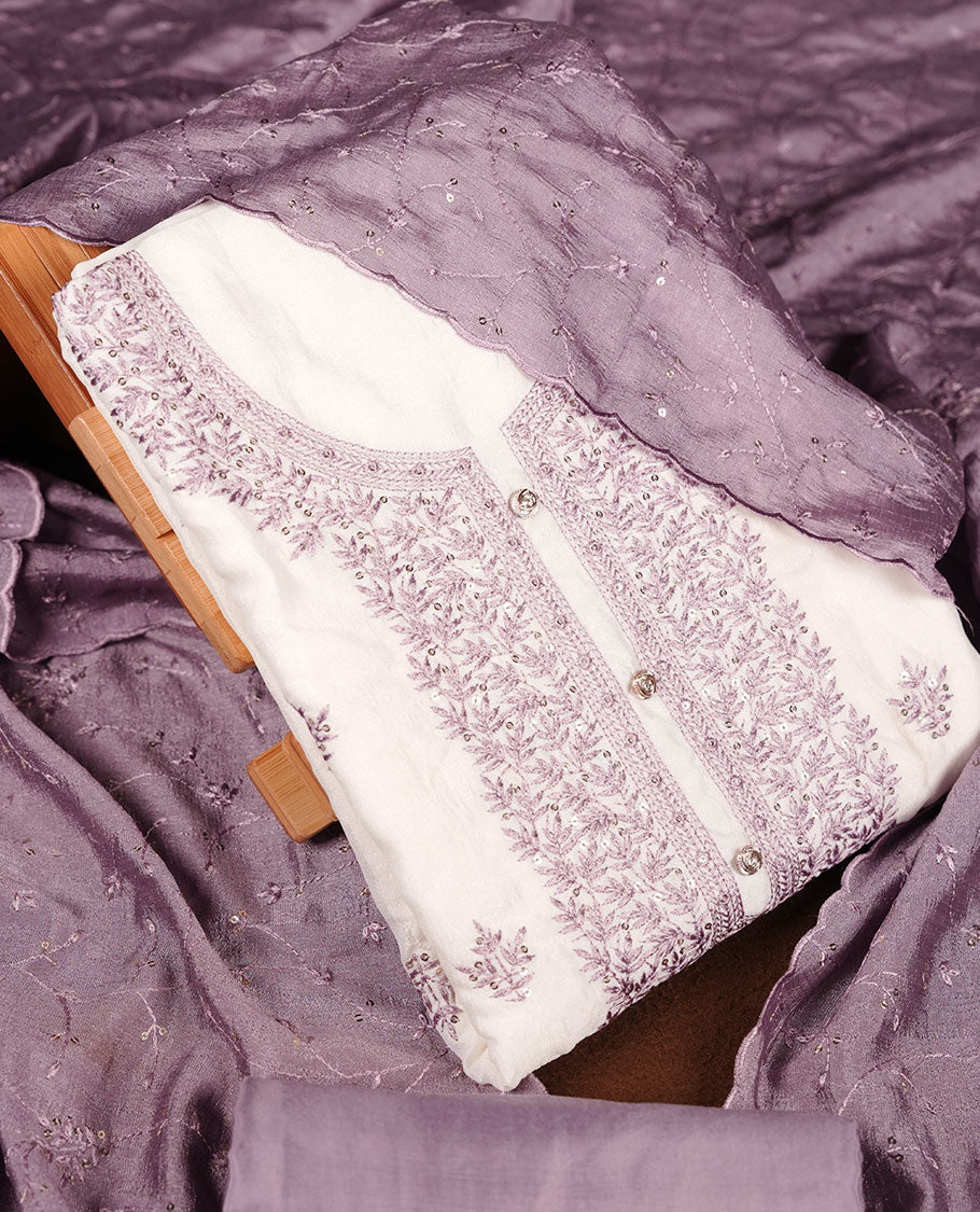 Ivory colour churidar material with lavender colour thread embroidery on the front panel, paired with a lavender matching dupatta and bottom.