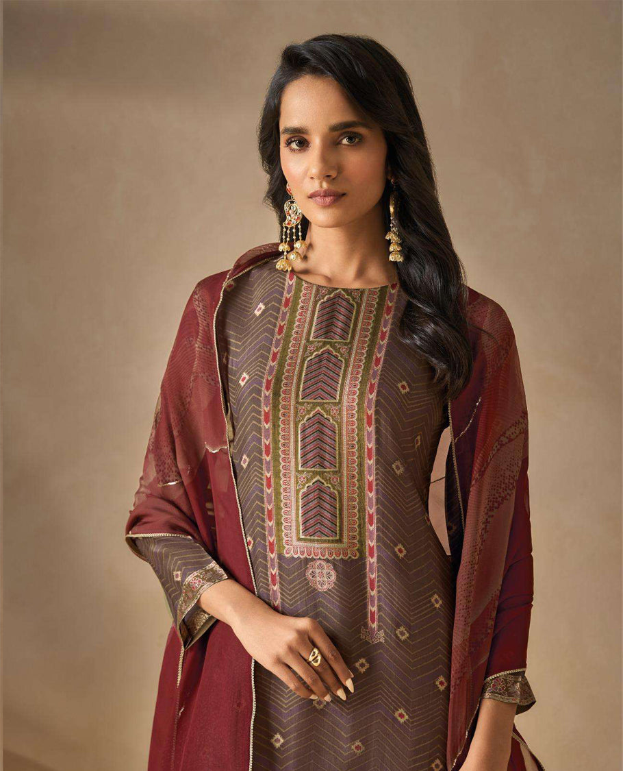 Brownish Gray colour suit material with silk jacquard digital print top with embroidery highlighted sleeve work, paired with matching satin bottom and a contrast lightweight printed dupatta.