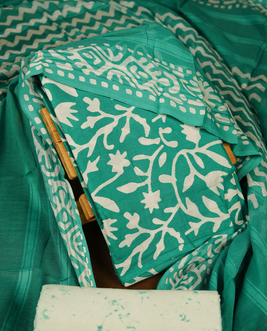 Persian Green colour churidar material featuring white floral printed body, paired with a matching chevron printed dupatta.