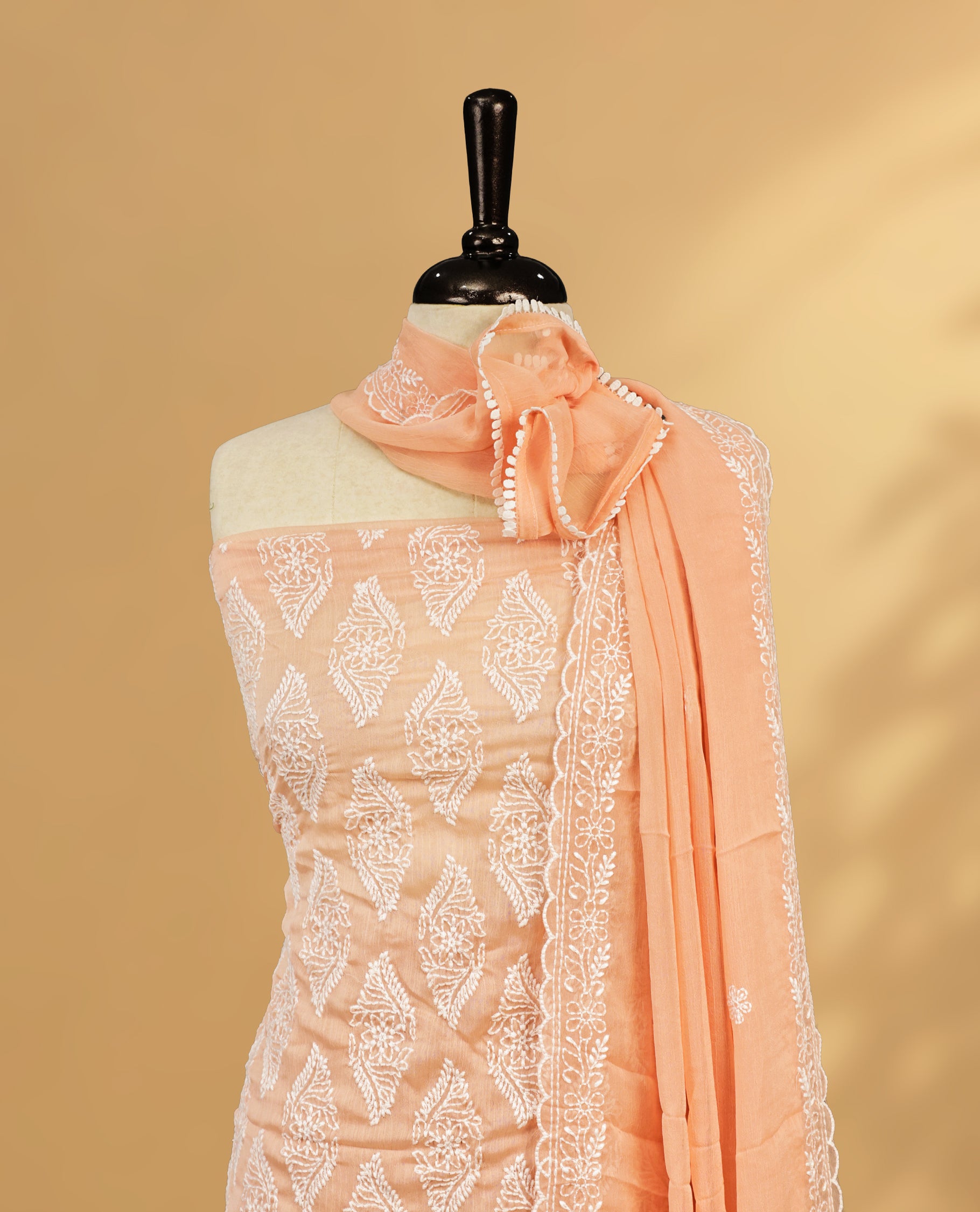Light Peach colour Salwar Material Featuring White colour Thread Pattern on body, paired with matching bottom & elegant Dupatta.