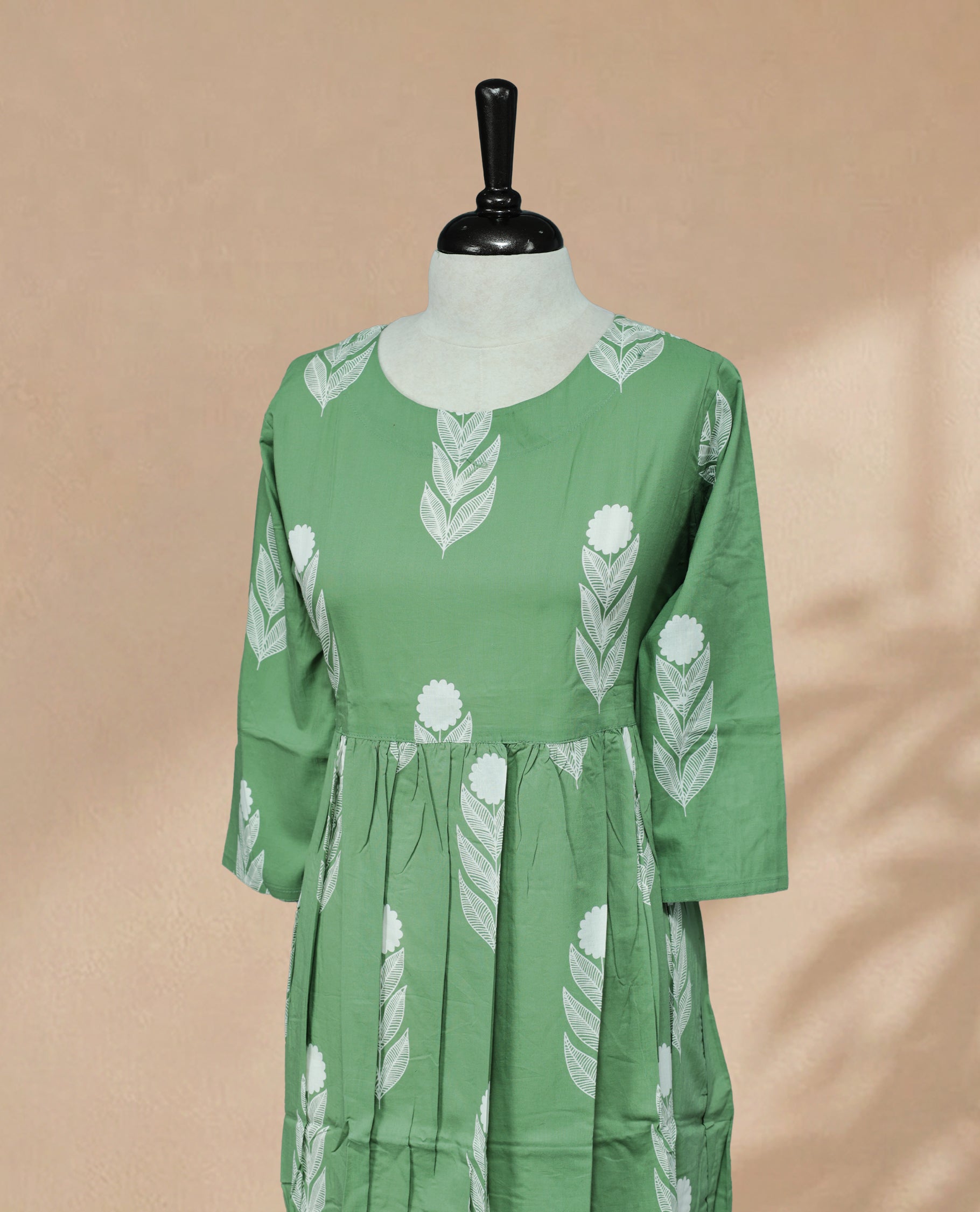 Pista Green Kurti featuring white digital Plant prints across the body, a round neckline, and a 3/4-sleeve design.