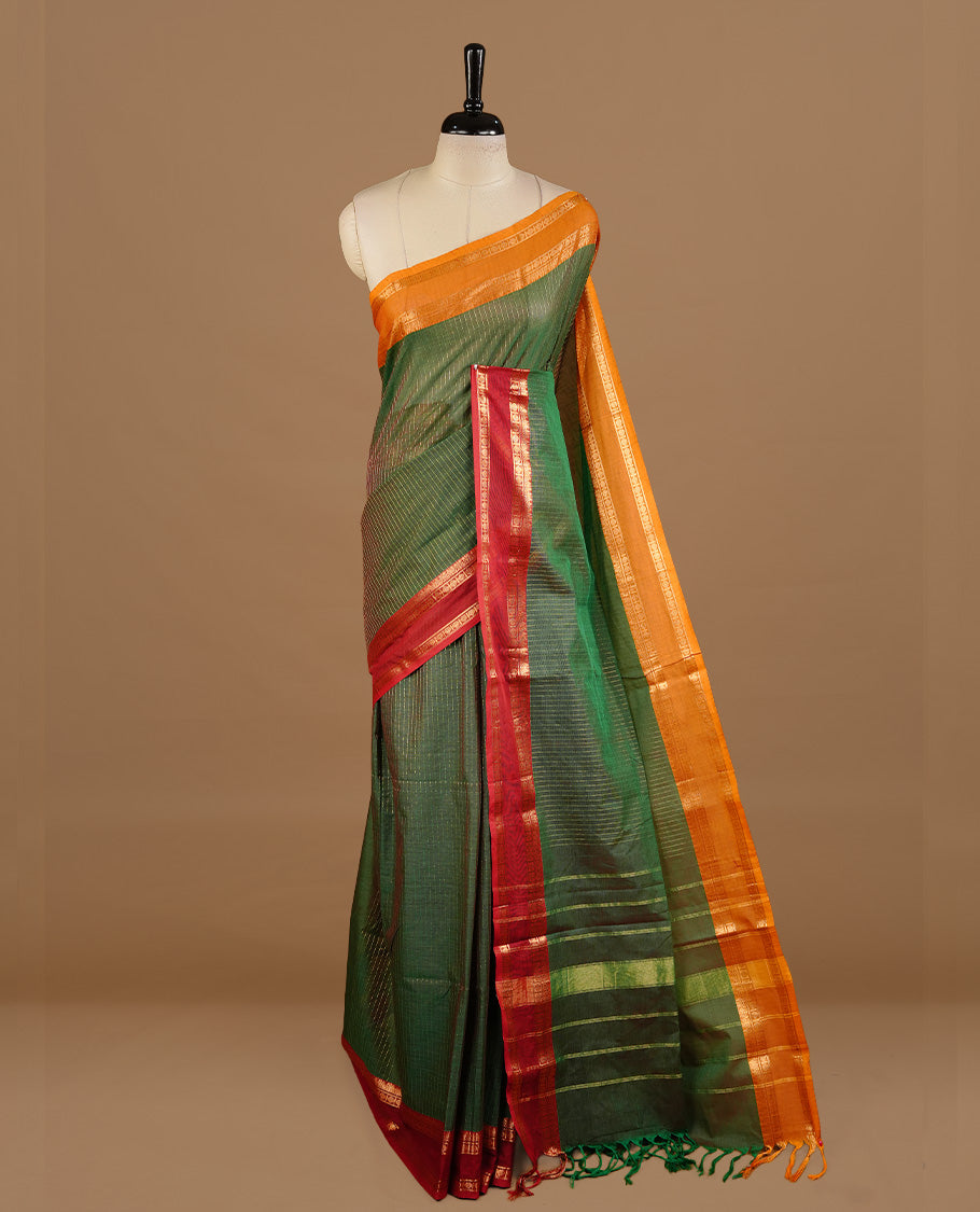 Green colour chettinad cotton saree featuring gold zari stripes on body, complemented by red colour with zari border, paired with matching blouse piece.
