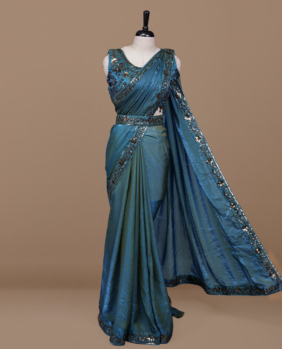 Gold & blue double shade designer saree features Elegant plain body, highlights Sequins & cut beats on border, paired with ready made blouse.