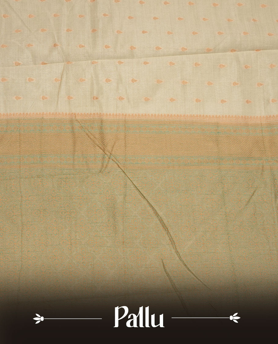 White gold colour semi tussar saree featuring Gold zari buttas body, contrast Ice blue colour gold zari border and comes with matching blouse piece.