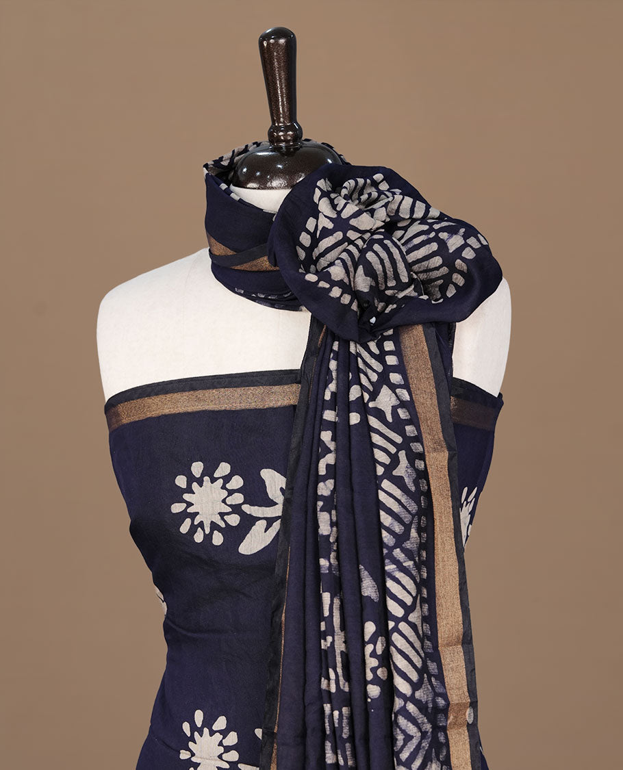 Dark blue colour churidhar material featuring cream colour floral kodi print on body, paired with matching bottom and Dupatta.