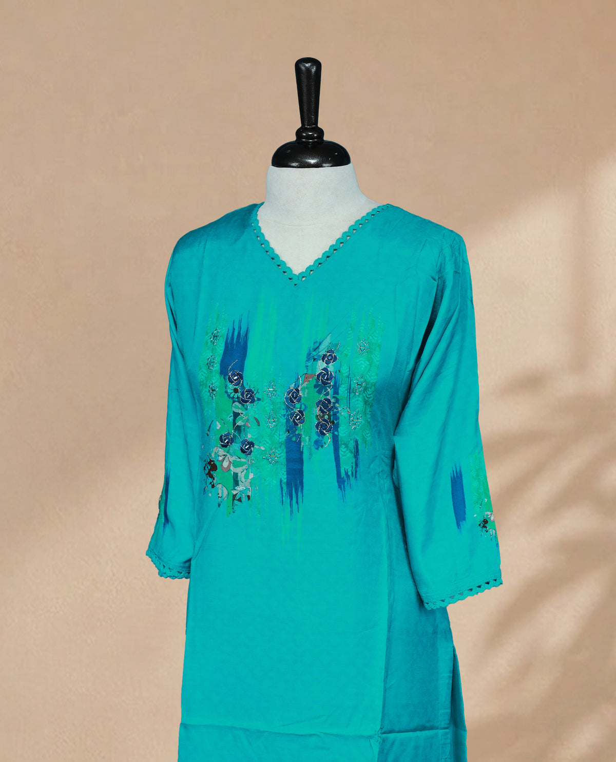 Teal Blue Colour Kurti featuring Floral embroidered detailing on Chest Side, a V-shaped neckline with lace detailing, and 3/4 sleeves with matching lace accents.