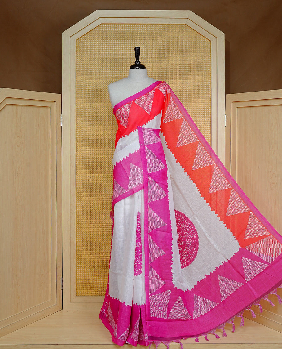 Cream colour semi linen saree featuring Pink Ajrakh pattern print on body, complemented by contrast Red colour with same pattern print Pink border, comes with matching blouse piece.