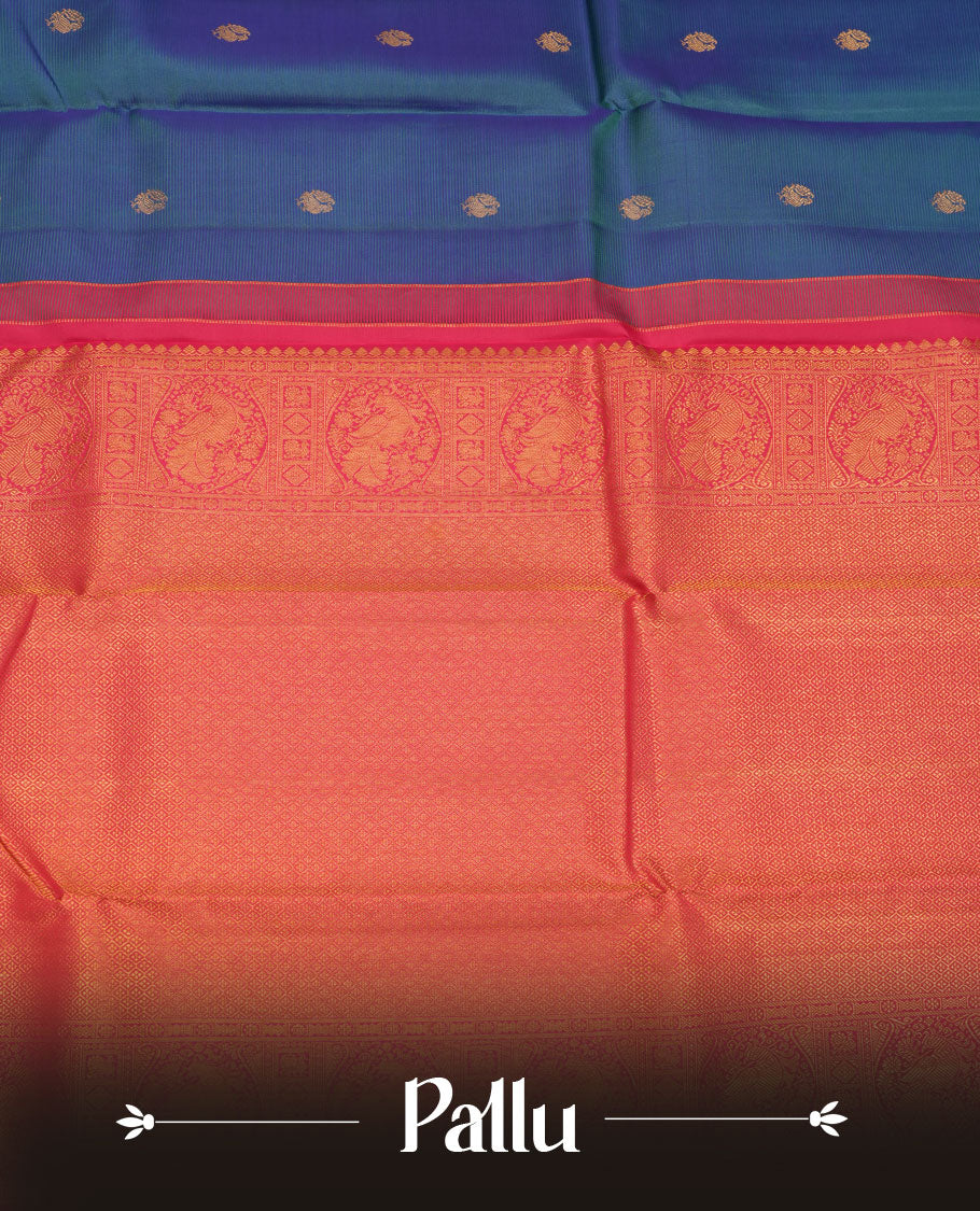 Peacock Blue colour pure traditional Kancheepuram silk saree adorned with gold zari peacock motifs across the body, featuring elegant contrast Pink traditional borders, beautifully paired with a matching blouse piece.