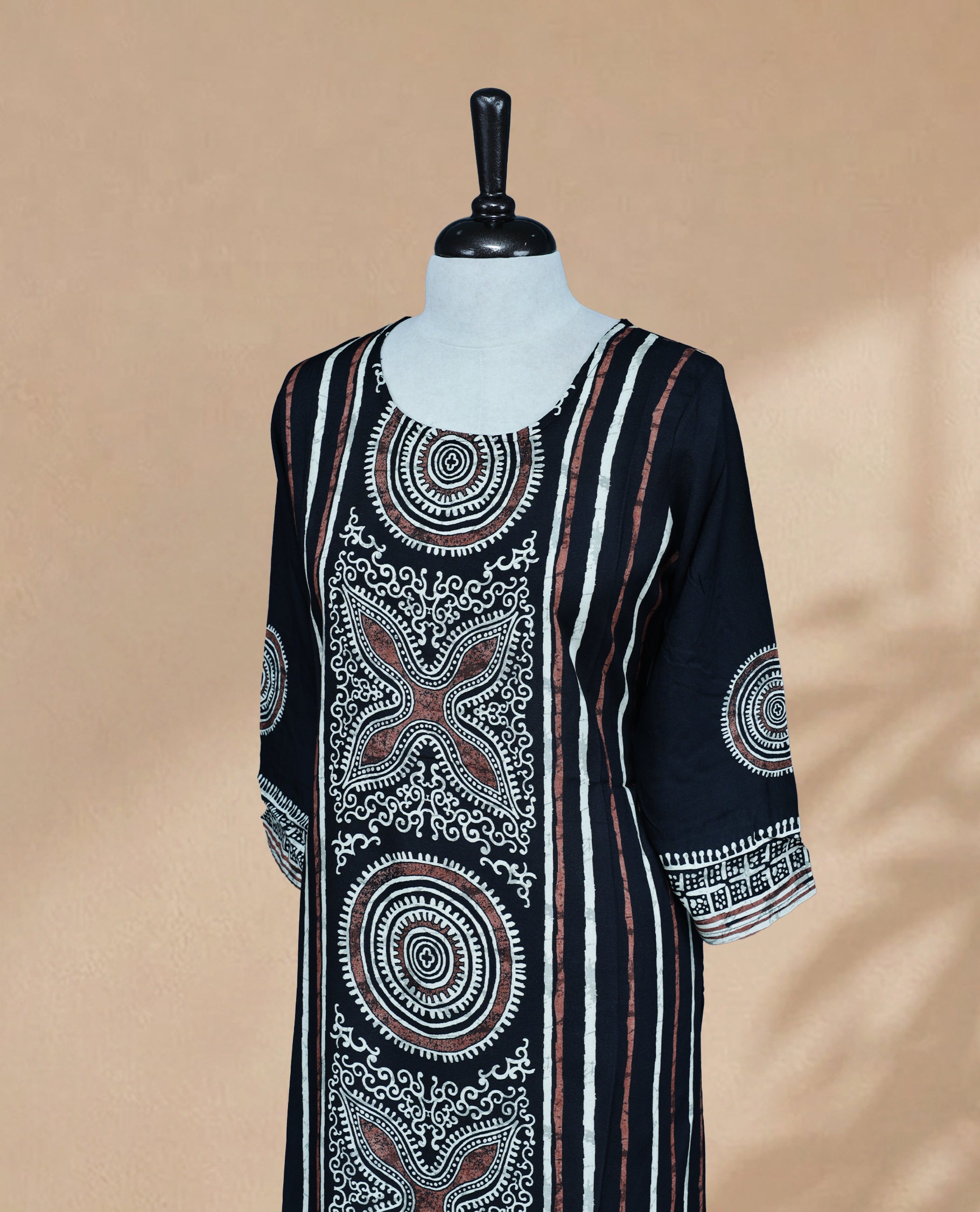 Black Colour Kurti featuring bold Cream & Brown Digital Prints On body , a round neckline, and 3/4 sleeve Design