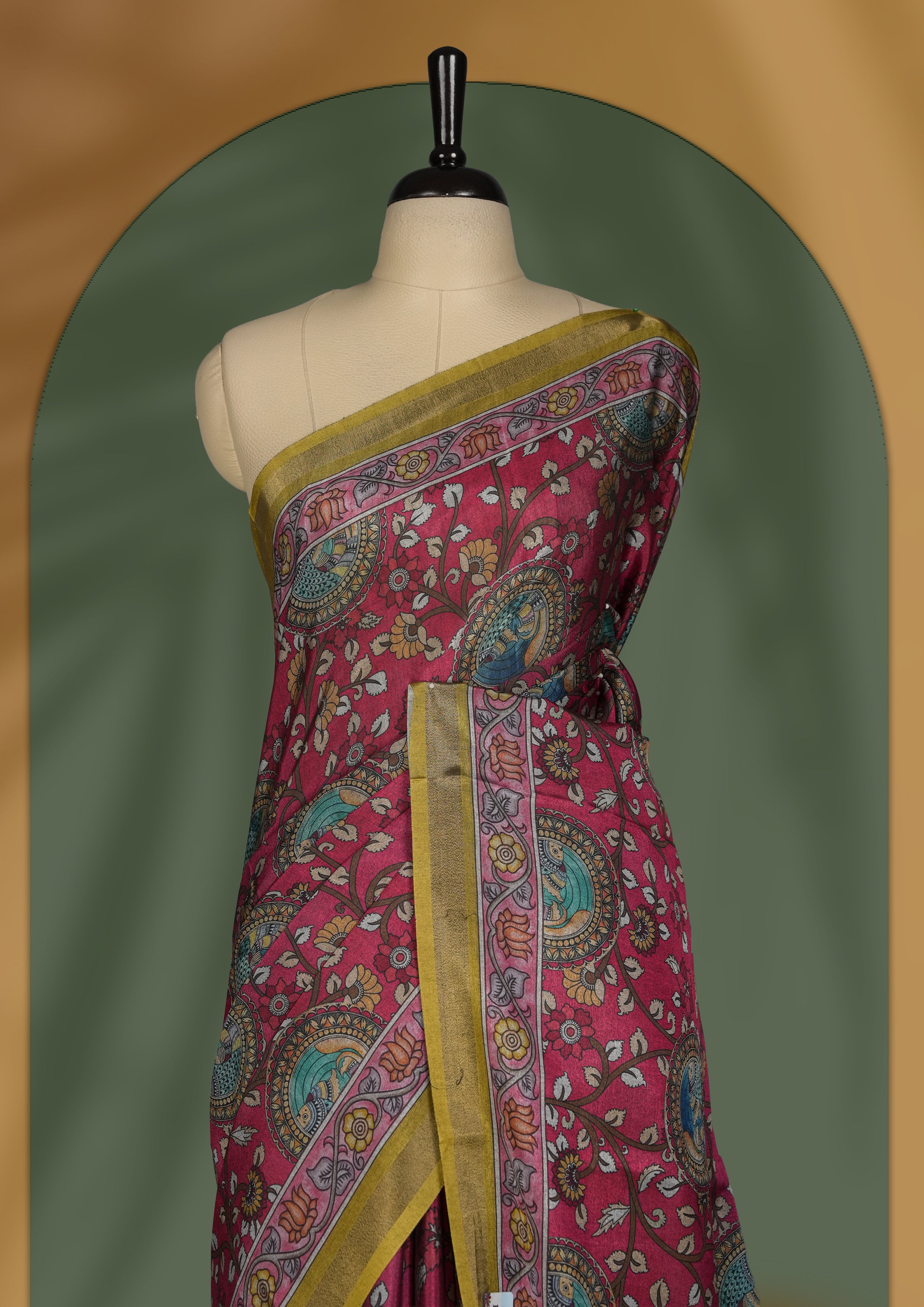 Reddish maroon colour saree adorned with intricate floral and paisley motifs, featuring a vibrant Madhubani style pallu and olive gold border & Paired with a matching blouse.