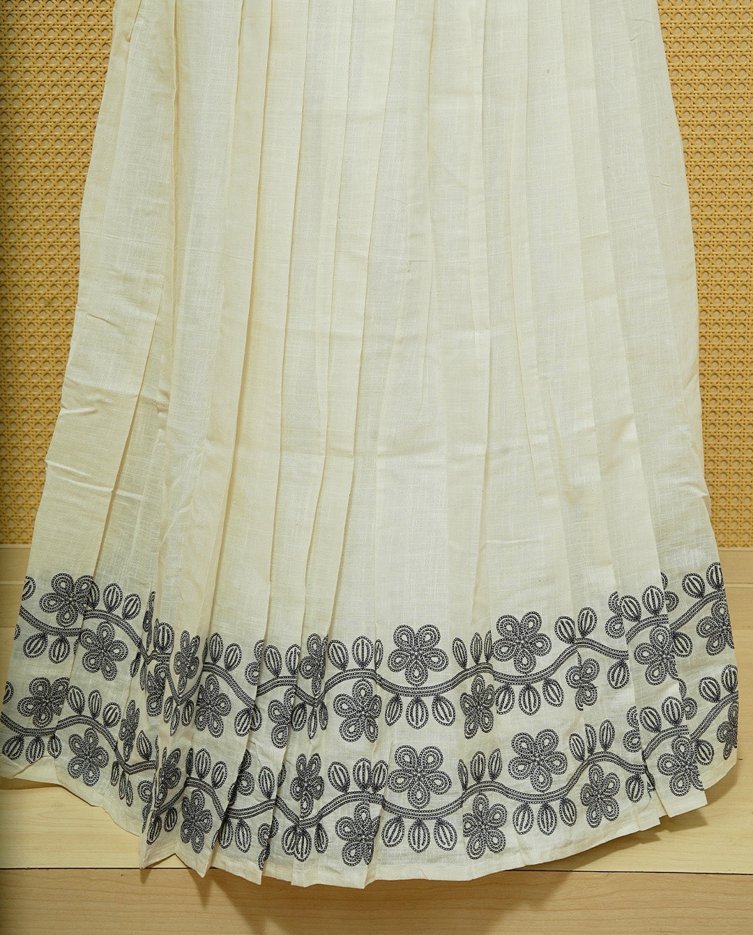 Cream colour cotton Stitched Skirt With Blue colour Floral thread pattern on the border.