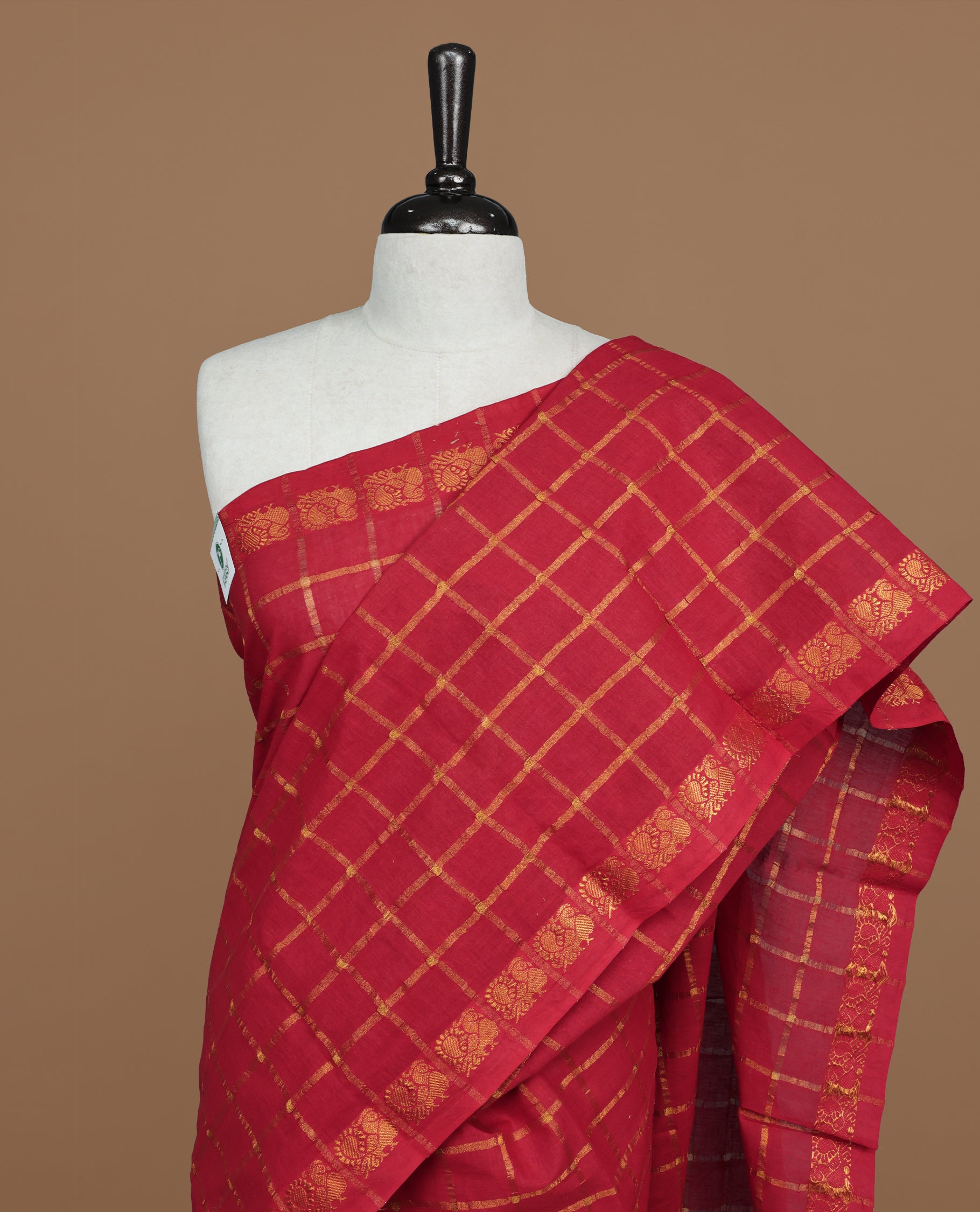 Red colour Sungudi cotton saree featuring Gold zari Check pattern on body, Gold zari Peacock design on Self colour border, paired with matching blouse piece.