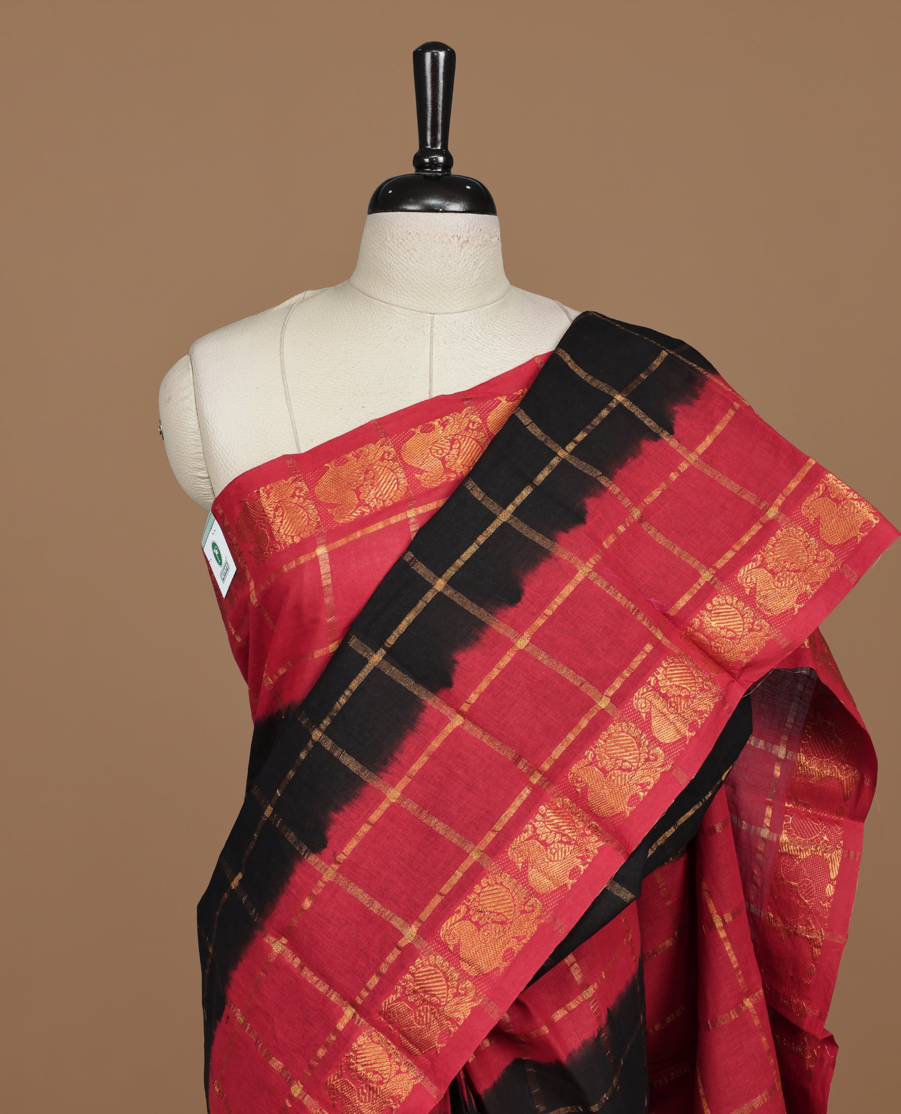 Black colour Sungudi cotton saree featuring Gold zari Check pattern on body, Gold zari Peacock design on Dyed Red colour design border, paired with matching blouse piece.