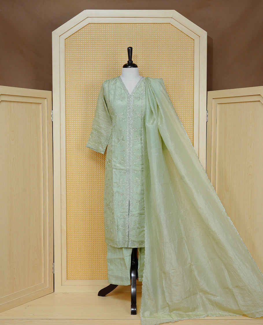 Pastel green colour churidar set with floral Stone & thread embroidery work on the V-neckline, paired with a matching embellished dupatta and solid pants.