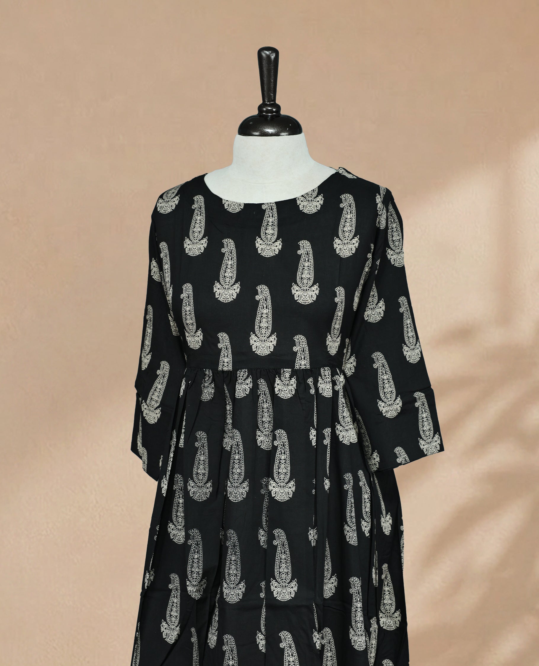 Black kurti featuring a classic U-shaped neckline, Cream Digital Prints on the body, sleeves.