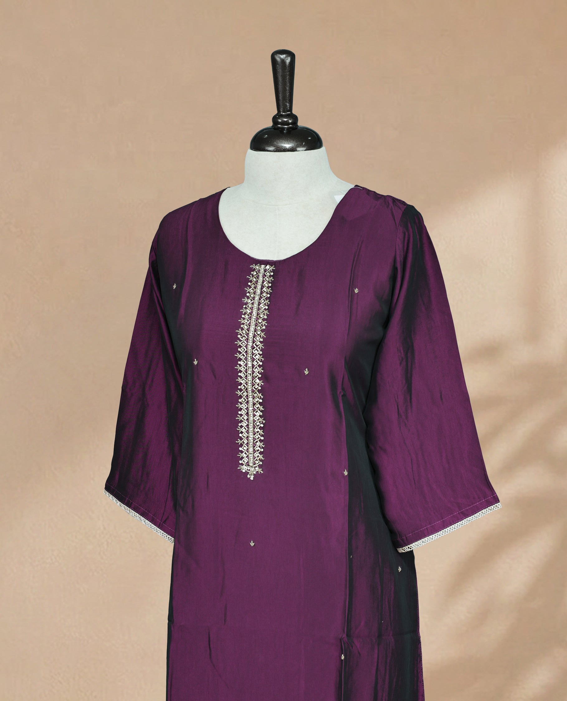 Purple Colour Kurti featuring beadwork across the body, a U-shaped neckline adorned with bead and Stone work and a 3/4 Sleeve With A Matching design.