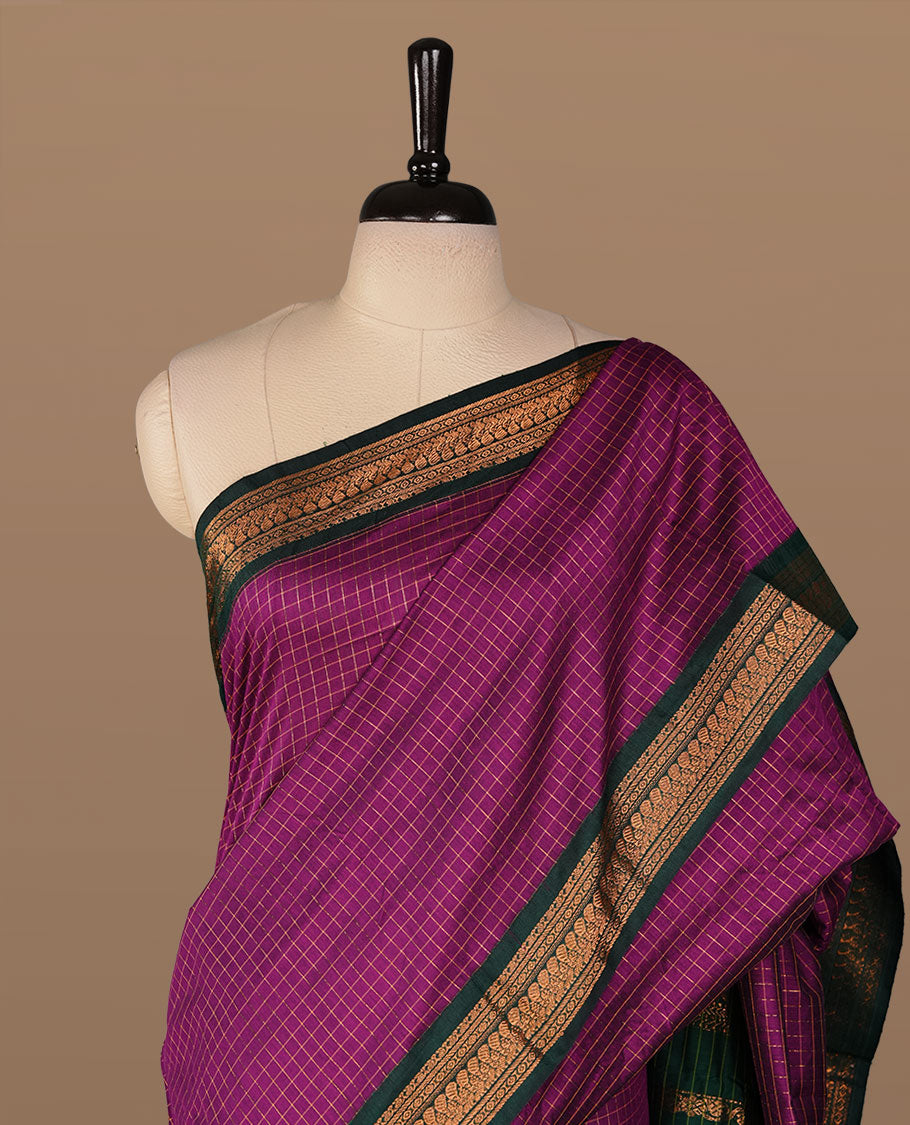 Purple colour kalyani cotton saree featuring gold zari check pattern on body, complemented by green colour with Antique zari border, paired with matching blouse piece.
