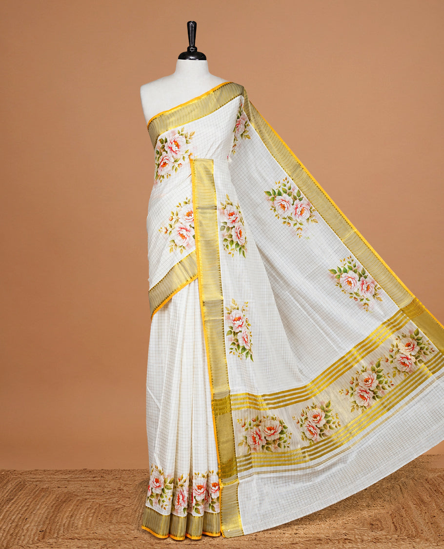Cream color kerala saree featuring Gold zari Checks on body, enrich Gold zari with floral printed border & pallu, paired with matching blouse piece.