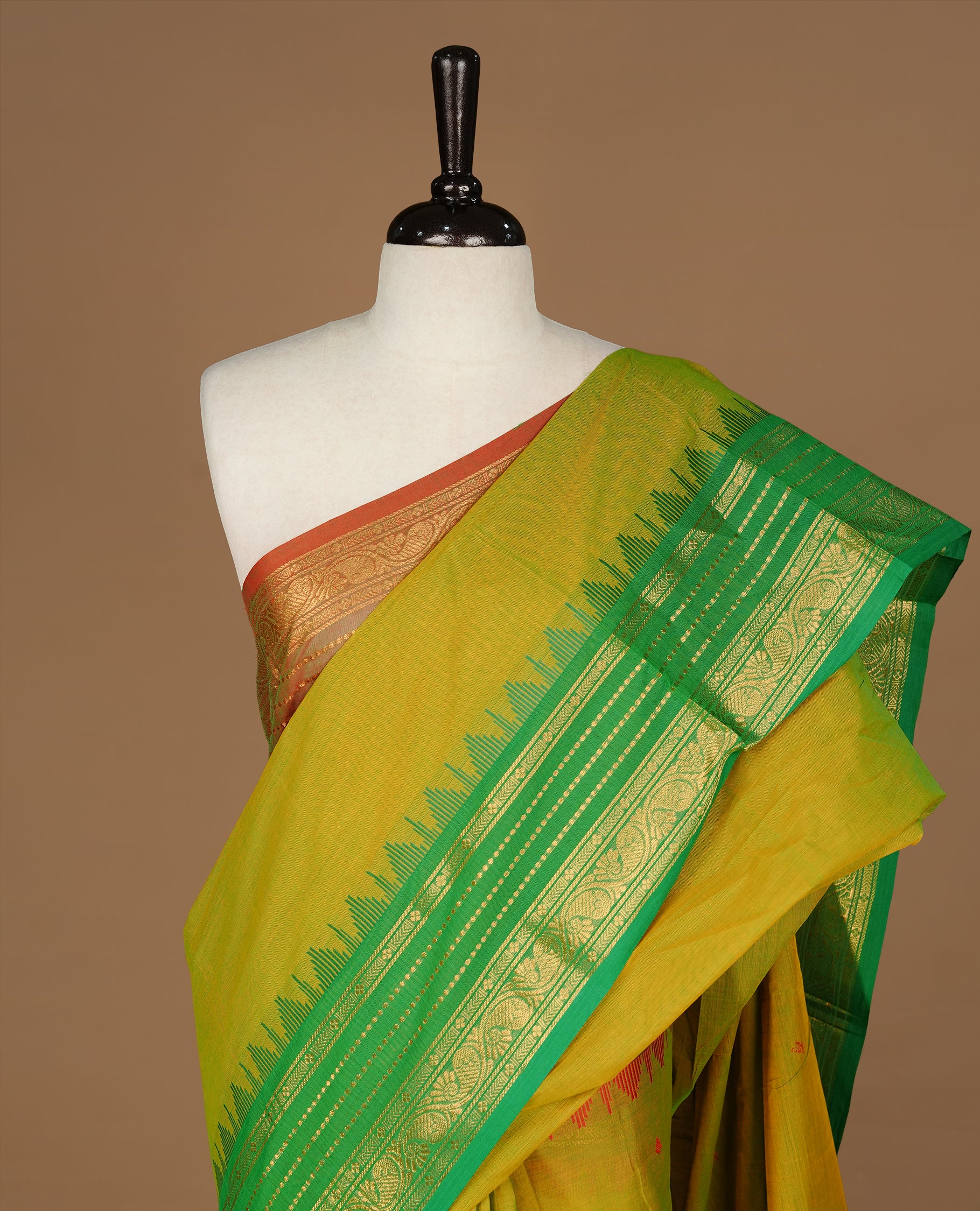 Moderate Olive colour Chettinad cotton saree featuring motifs on body , complemented by contrast Green colour with zari border, comes with matching blouse piece.